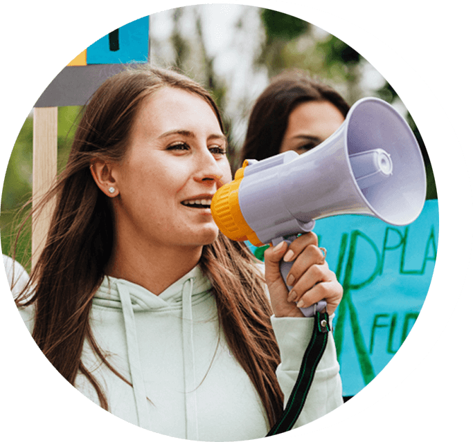 A woman holding a megaphone in front of her face.