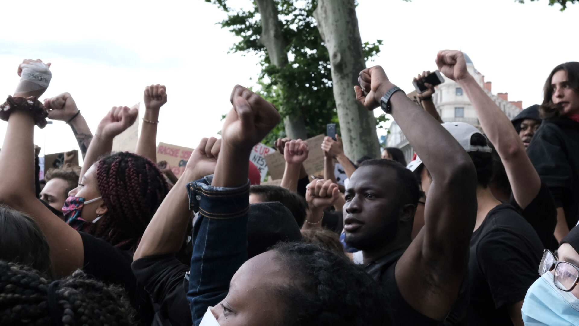 A group of people with their hands up in the air.