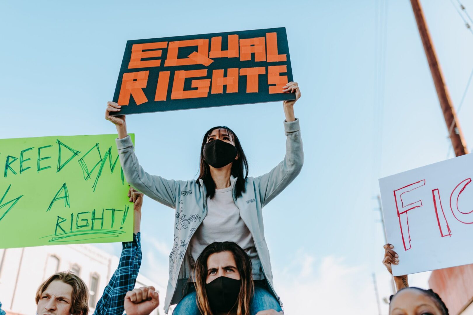 A woman holding up an equal rights sign.